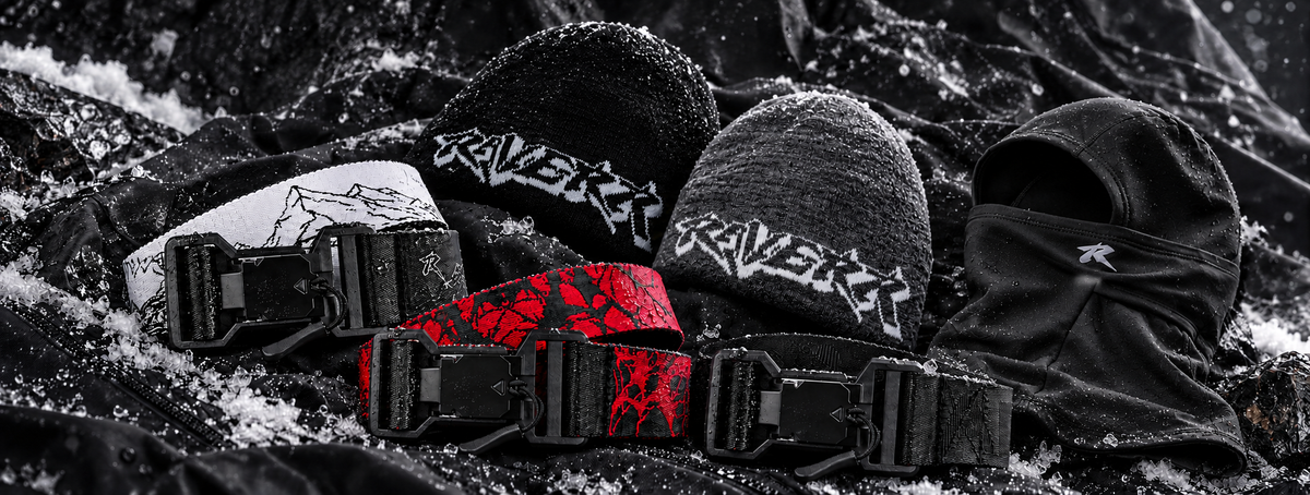 Railerr belts, beanies and balaclava on snow-dusted black fabric